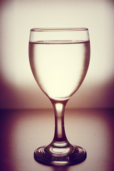 Drinking cold water into a three glass placed on the wooden table.