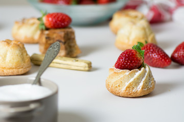 mini vanilla cakes decorated with strawberries in season
