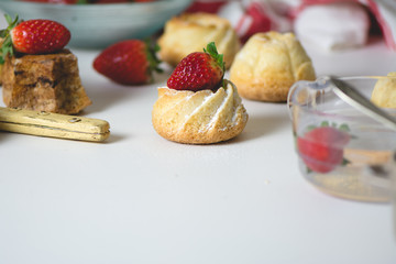 mini vanilla cakes decorated with strawberries in season