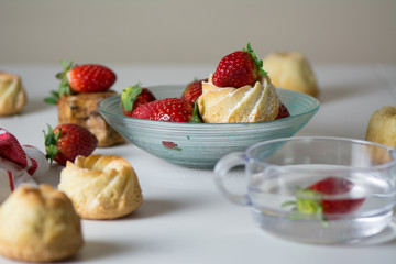 mini vanilla cakes decorated with strawberries in season