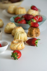 mini vanilla cakes decorated with strawberries in season