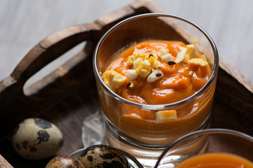 salmorejo in crystal glasses, in a wooden tray