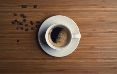 Coffee cup top view on wooden table background