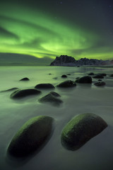 Aurora borealis over a beach on the Lofoten in Norway - 103112304