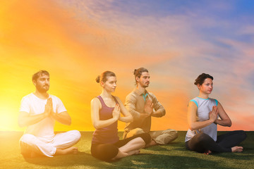 The group of people doing yoga exercises 