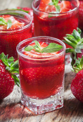 Strawberry juice and fresh berries with mint, selective focus