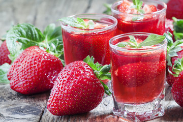 Strawberry juice and fresh berries with mint, selective focus