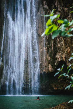 Fototapeta Woman contemplating a waterfall