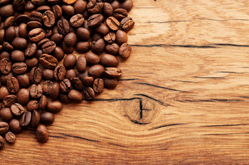 Coffee beans on grunge wooden background