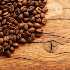 Coffee beans on grunge wooden background