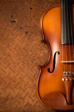 Vintage violin with old steel background with copy space
