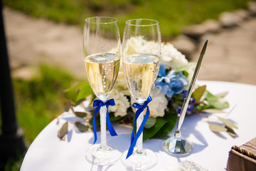 Stylish wedding glasses with champagne standing on the table