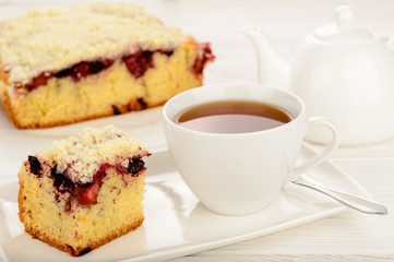 Sweet homemade cake with berries and cup of tea