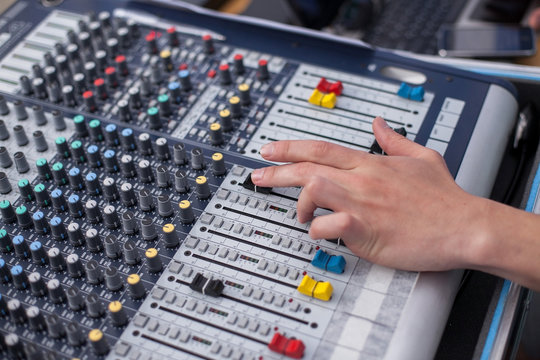 mixing panel. a hand of the person on the mixing panel