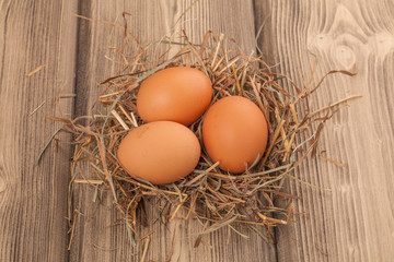 Group of Easter eggs in a nest on sacking.
