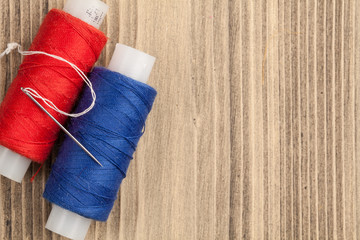 thread coil on old wooden background. Top view.