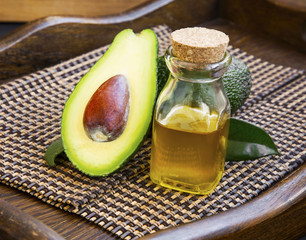 Avocado oil in bottle with avocado fruit © marrakeshh