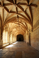 Fototapeta premium Carved arched corridor in monastery. The carved arched corridor in the monastery of Jeronimos in Lisbon, Portugal (Mosteiro dos Jeronimos) 