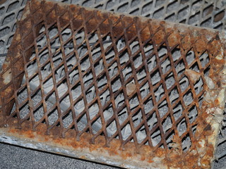 Rusted steel drain grate closeup