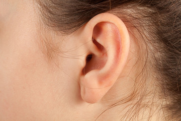 Young woman ear closeup.