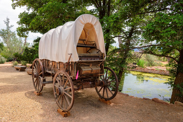 Nice old covered wagon in Arizona and lake in background