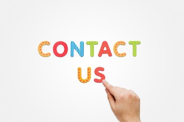 Hand put the words Contact Us with magnetic letters