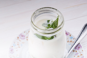 Open glass jar of yogurt