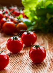 Tomatoes on wooden background, selective focus
