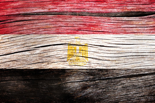 Egypt flag painted on the old cracked wood with worn-out paint. Grunge look.