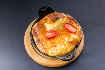 Fresh ham and cheese omelet in fry pan