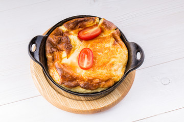 Fresh ham and cheese omelet in fry pan
