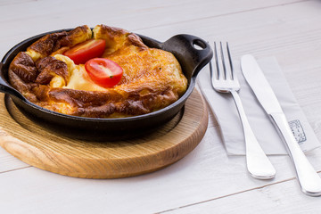 Fresh ham and cheese omelet in fry pan