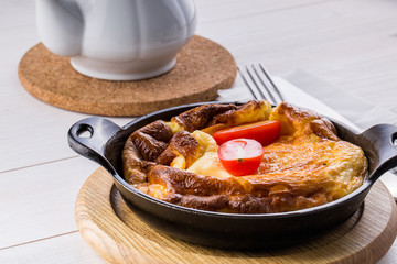 Fresh ham and cheese omelet in fry pan