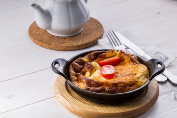 Fresh ham and cheese omelet in fry pan