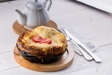 Fresh ham and cheese omelet in fry pan