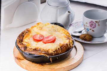 Fresh ham and cheese omelet in fry pan