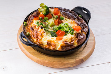 Fresh ham and cheese omelet in fry pan