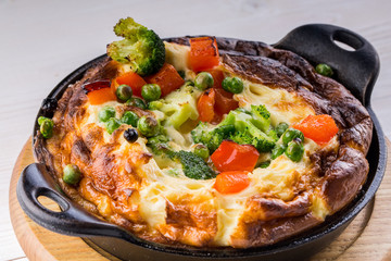 Fresh ham and cheese omelet in fry pan