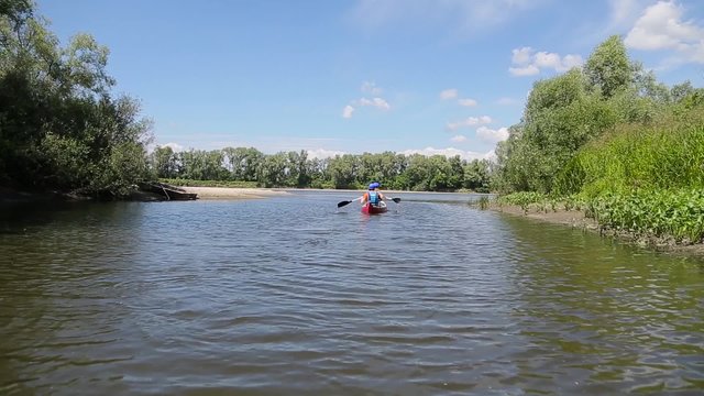 Two men in a canoe raft on river.