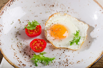 Breakfast with egg and tomatoes.