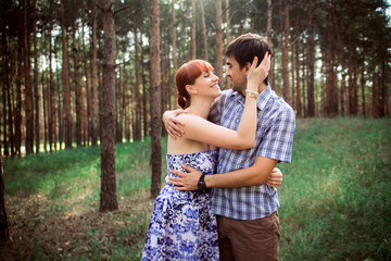 a young couple in love walking in the woods