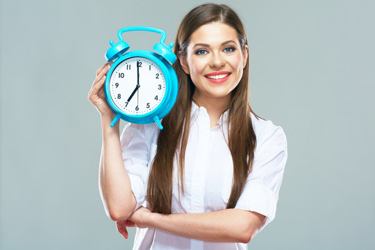 Smiling business woman hold alarm clock.