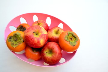 Red Apple and Persimmon in Basket