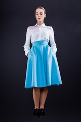 Beautiful young fashion business woman on black background