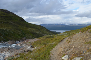 Hiking trail and mountain river in subarctic tundra valley, Swedish Lapland