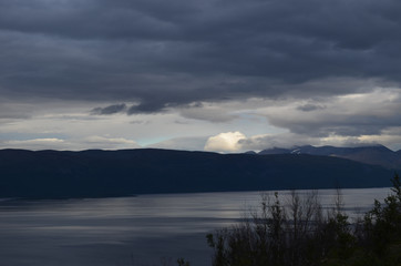 Mountain lake Torneträsk on a cloudy evening