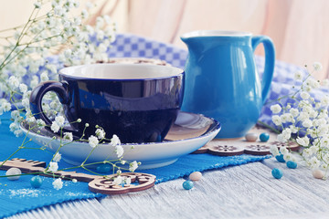 Cup of coffee with milk on a white wooden table