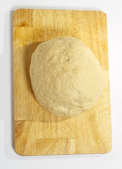 ball of raw dough over white background