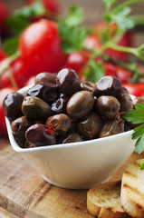 Olive with tamato and parsley on the wooden table