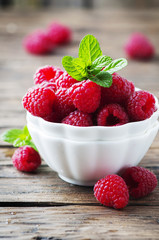 Sweet fresh raspberry and mint on the wooden table